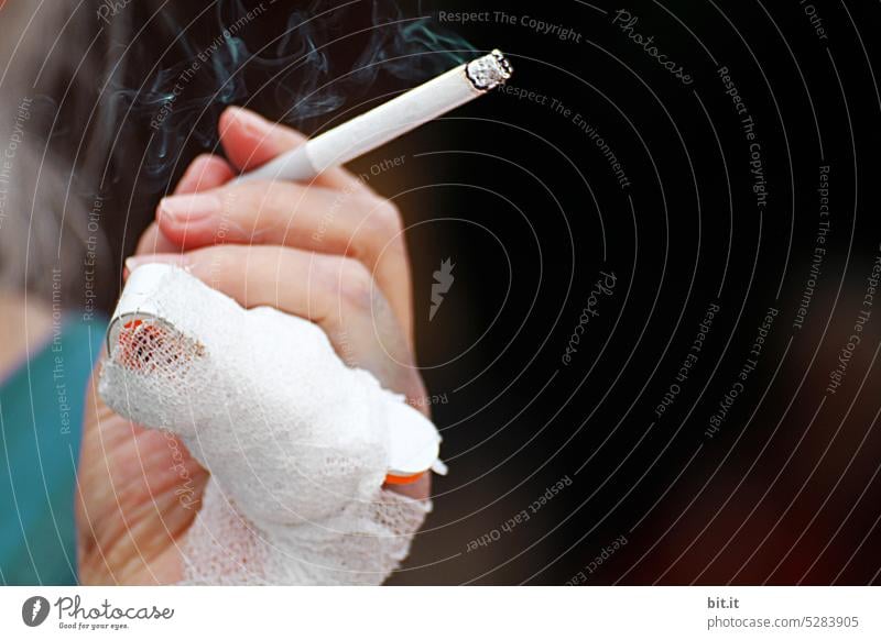 ¥MainFux l female hand holding smoking cigarette with smoke. Hand, finger with injury, bandage, fracture against dark background. Woman with gray hair smoking cigarette after accident. Hospital, nerves, injury, unhealthy lifestyle, shock.