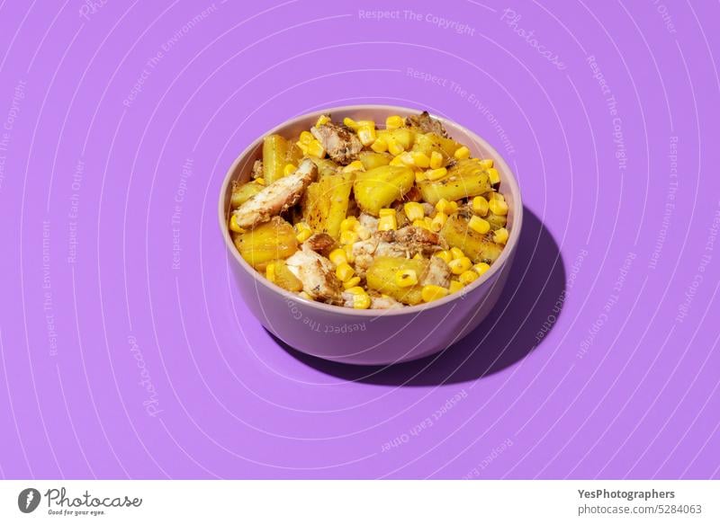 Tropical salad bowl, roasted chicken with pineapple, isolated on a purple background above ananas bright close up color copy space corn cuisine cut out