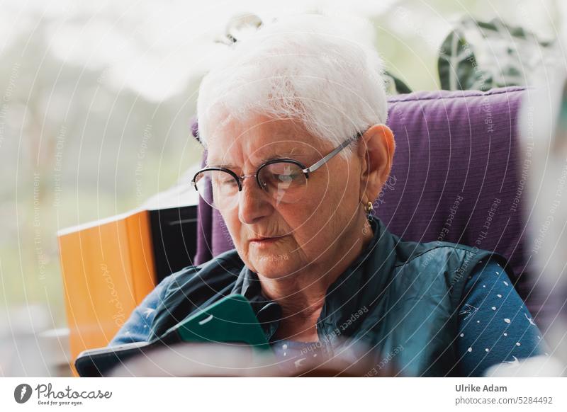 MainFux | Always up to date - woman reads on smartphone Woman Reading concentrated Eyeglasses grey hair Pensioner Senior citizen Self-confident news Cellphone