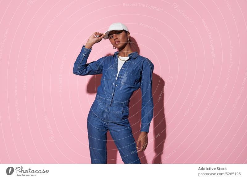 Stylish black woman in white cap in studio style denim fashion trendy outfit model apparel appearance jeans female ethnic young african american confident