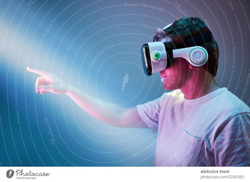 Anonymous man in VR headset vr explore glasses cyberspace goggles neon experience reality virtual male innovation gadget virtual reality simulate light