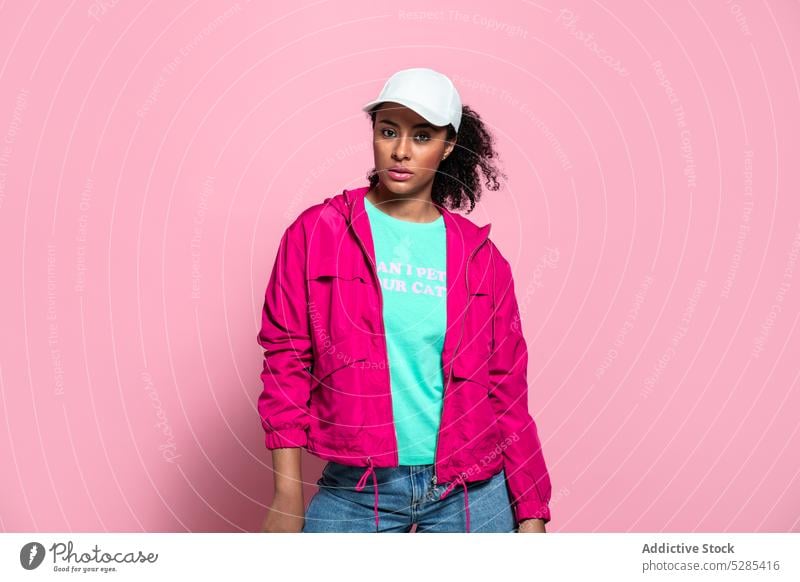 Dreamy black woman in casual outfit style confident serious trendy fashion appearance wear model bright female young cap cool african american individuality