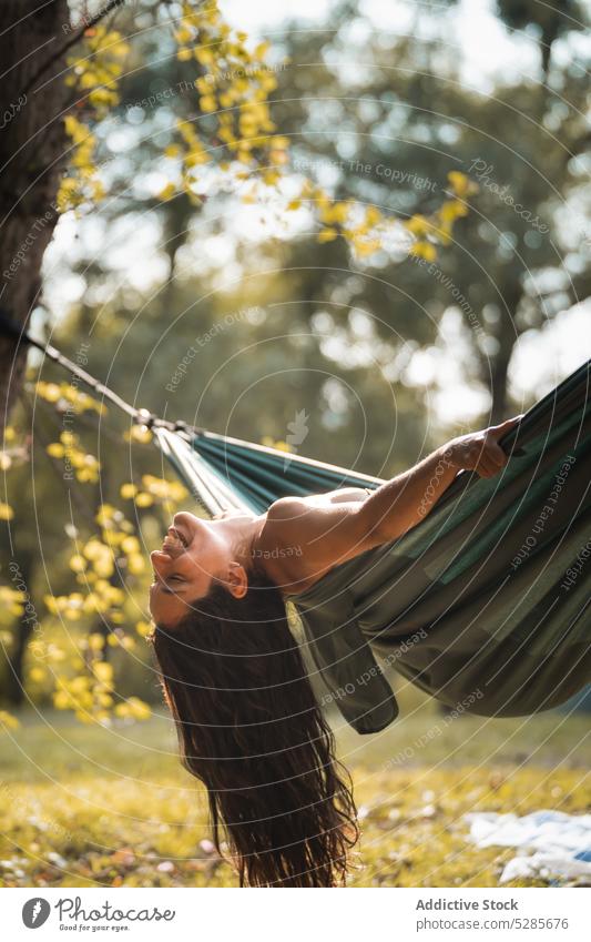 Woman sitting in hammock in forest woman relax lounge nature woods recreation park summer tree female spain sun calm tranquil daytime sunlight peaceful