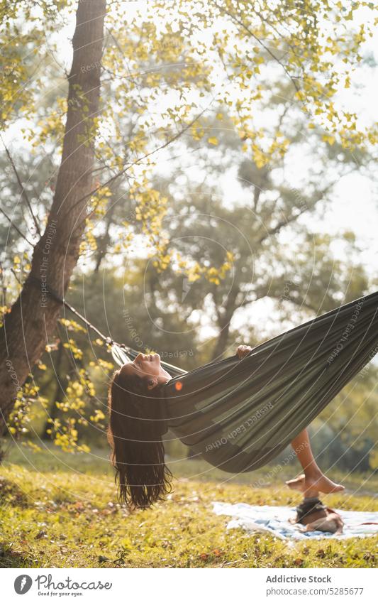 Woman sitting in hammock in forest woman relax lounge nature woods recreation park summer tree female spain sun calm tranquil daytime sunlight peaceful