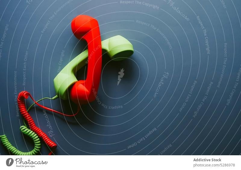 Red and green telephone handsets placed on table retro love support close connection distance relationship vintage concept creative romantic nostalgia minimal