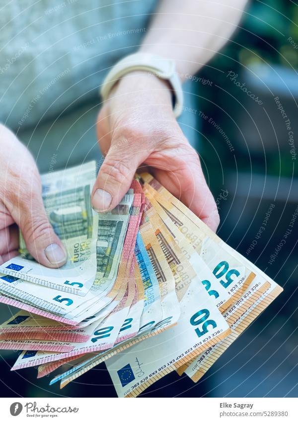 Euro banknotes in the hands ... who has that has Banknote Bank note Loose change finance Money Paying Business Income Economy Shopping Financial profit