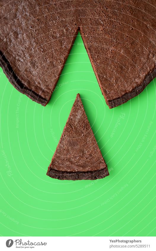 Chocolate tart slice, isolated on a green background above baked banner black brown cake calories chart chocolate circle close-up cocoa color copy space crust