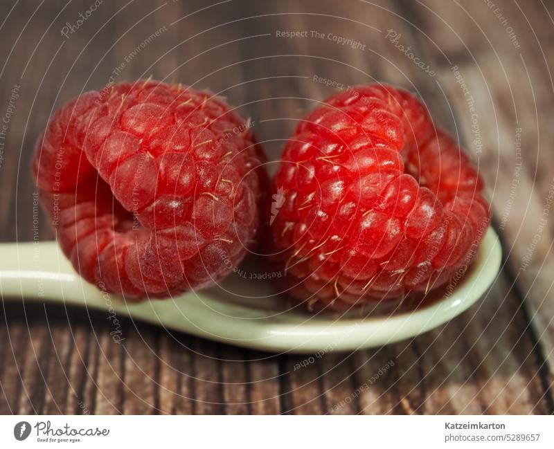 Two raspberrys on a spoon background breakfast closeup concept copy space delicious dessert diet eating food food concept fresh freshness fruit group health