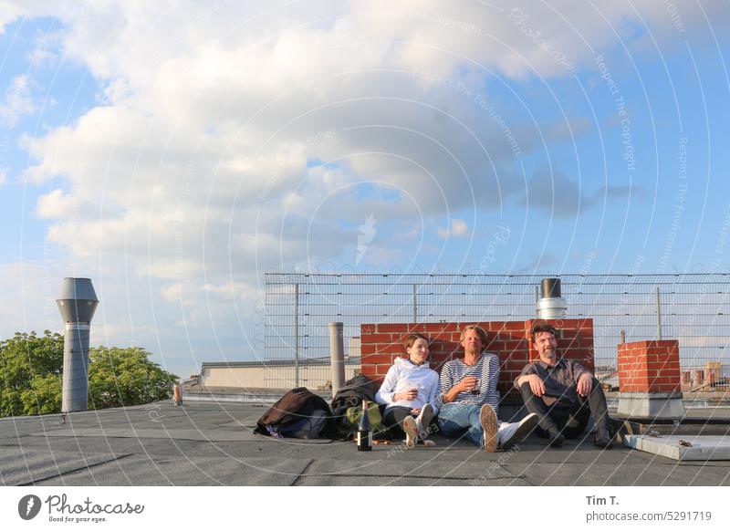 Three people on the roof relaxing Roof Prenzlauer Berg Vine Man Woman Chimney Town Berlin Exterior shot Downtown Capital city Old town Day Colour photo