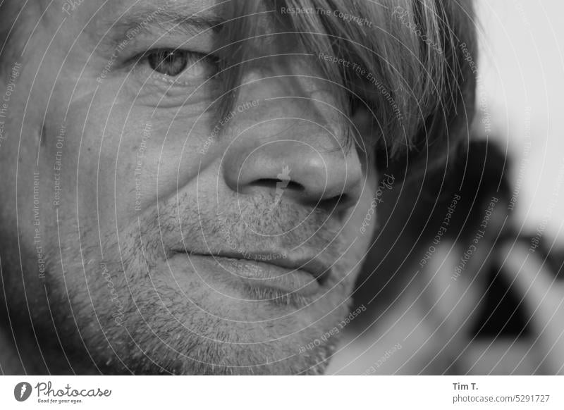 man with hair on face looks at camera Man Hair and hairstyles Eyes Designer stubble b/w bnw Black & white photo Day Exterior shot Berlin Downtown Town