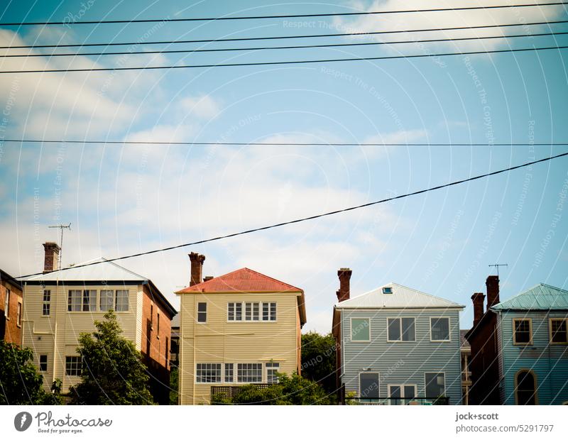 a number of homely houses House (Residential Structure) Tasmania Hobart Facade Sky Style Australia good weather Clouds Authentic in a row equality power cable