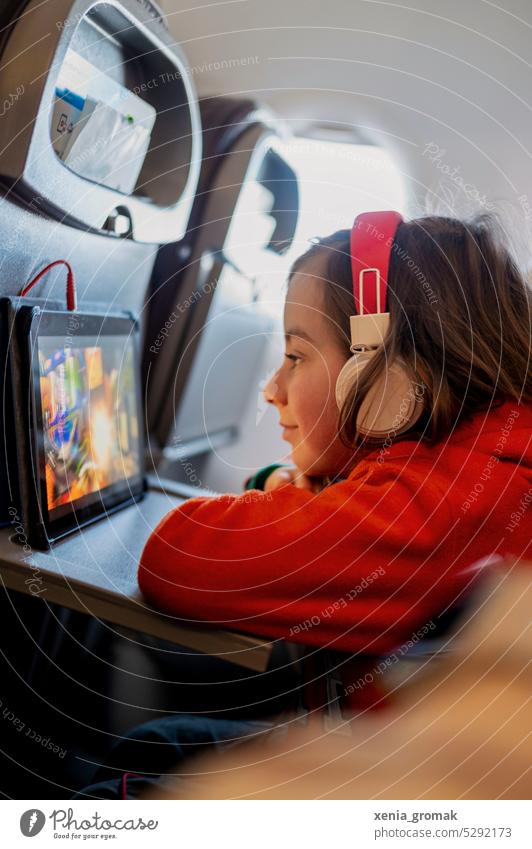Child on plane Infancy Airplane flight vacation Vacation & Travel school holidays Tourism Screen time netflix Headphones Parenting Passenger Departure Trip
