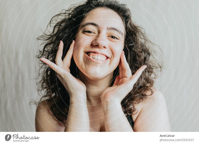 Portrait of a joyful woman with her hands on her face expressing happiness smile happy portrait cheerful positivity emotions expression beauty female people