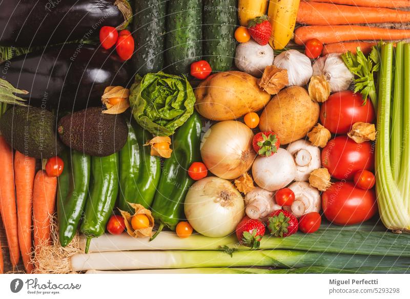 Background created with fruits and vegetables,cucumbers,eggplants,potatoes,peppers,garlic,mushrooms,lettuce,carrots,leek,celery,strawberries,physalis,tomatoes,avocados and cucumber,vegetarian background.