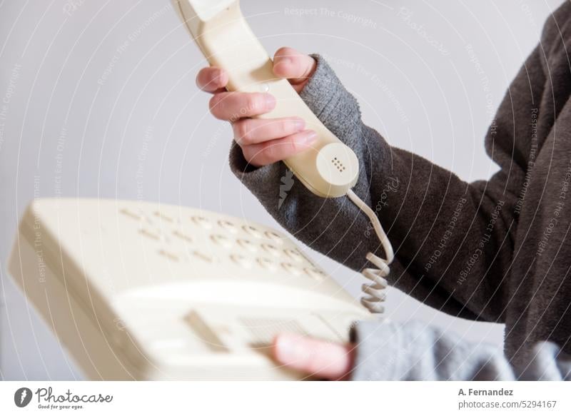 Woman holding the receiver of an old retro telephone device. concept of changes in ways of communication Telephone old phone Telephone connection