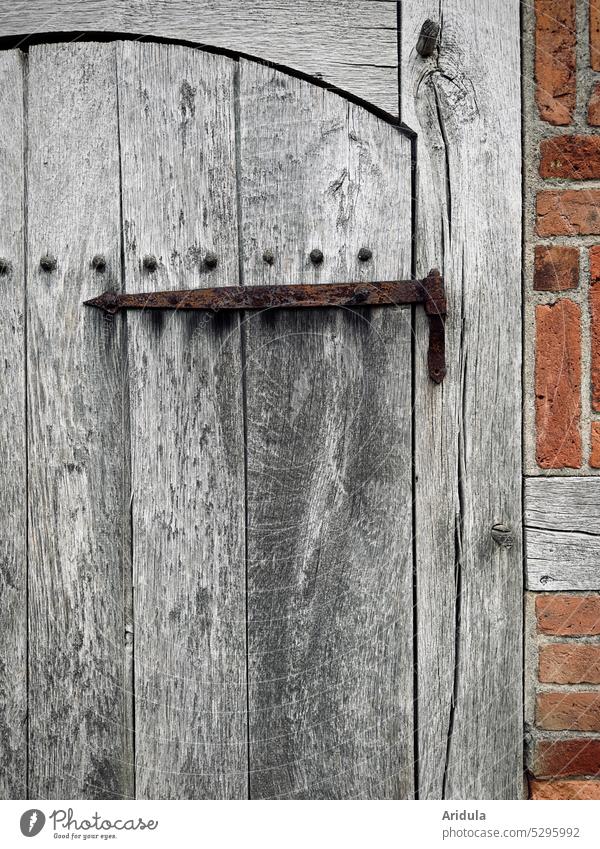 Part of an old grayed wooden door with rusted hinge Wood Wooden door Old Doorangel Rust corroded half-timbered Brick Wall (barrier)