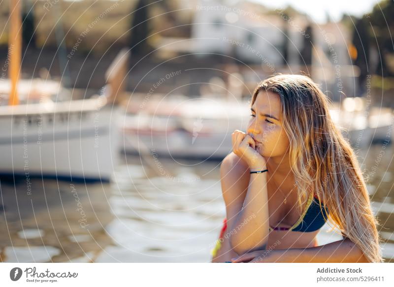 Positive woman chilling on yacht in port traveler boat rest summer weekend girona female spain cadaques beach tourism adventure freedom ocean sea coast