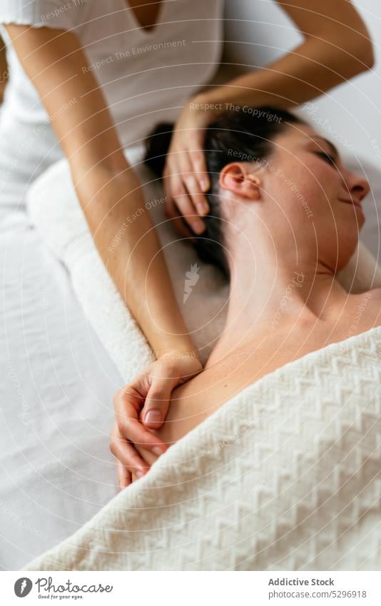 Crop therapist doing body massage to female client in spa salon women relax masseur procedure rehabilitation therapy treat specialist patient calm care wellness
