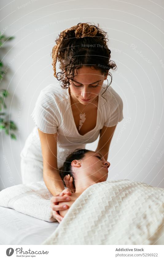 Woman therapist doing body massage to female client in spa salon women relax masseur procedure rehabilitation therapy treat specialist patient calm care