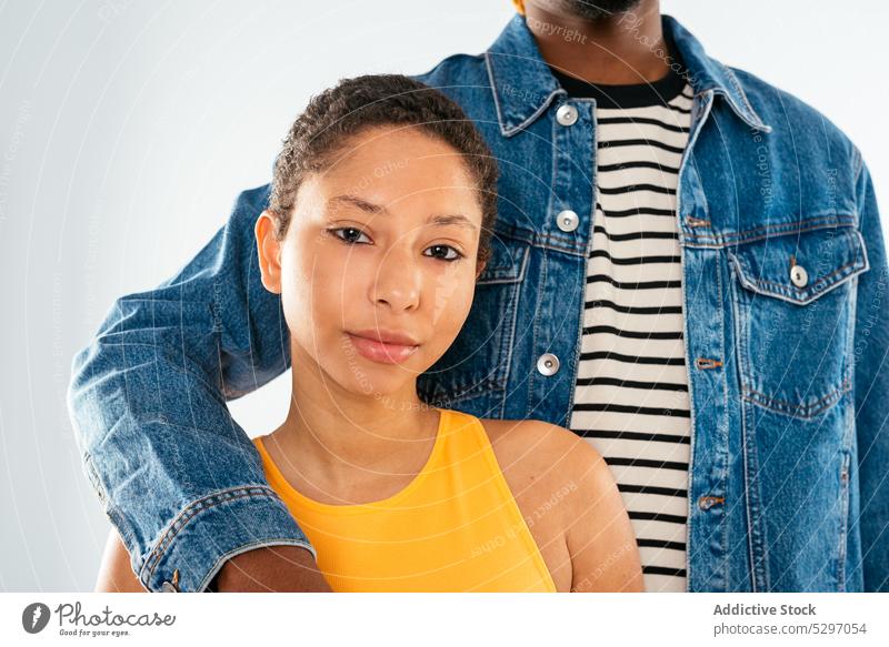 Ethnic couple embracing on white background boyfriend girlfriend relationship embrace hug jeans street style denim african american ethnic black love dreadlocks