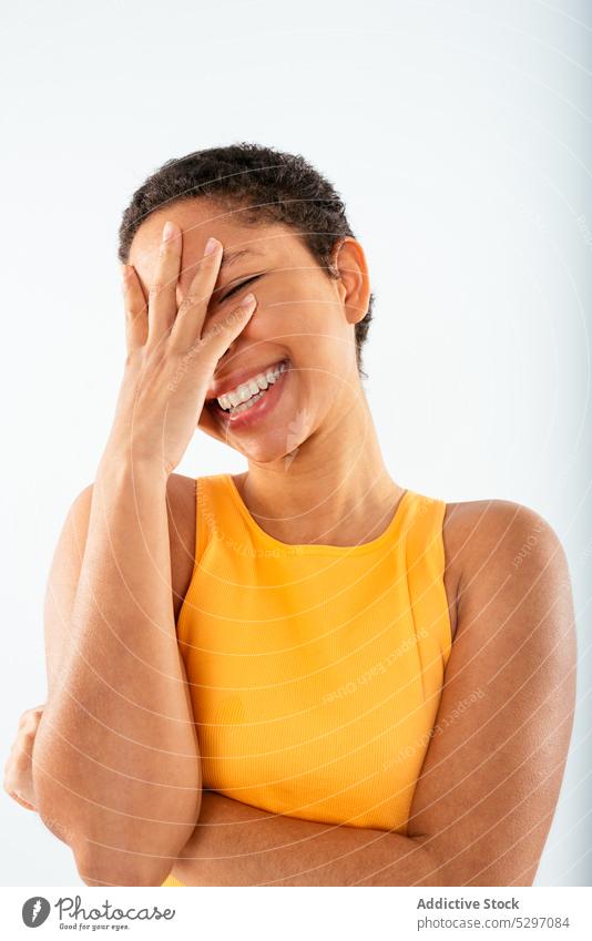 Cheerful black woman covering face smile cheerful facepalm cover face gesture style happy studio shot joy young african american ethnic female positive top