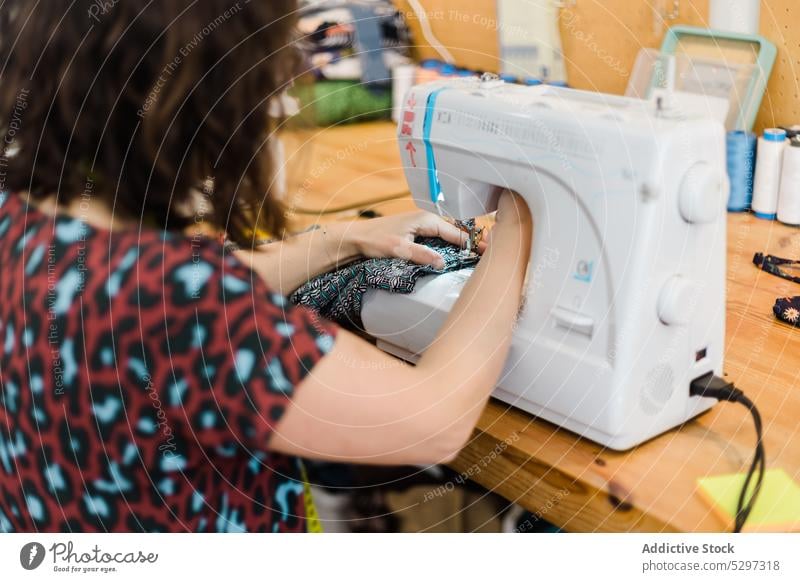 Crop seamstress sewing on machine woman thread tailor dressmaker sewing machine work atelier sewer workshop handicraft female small business equipment design