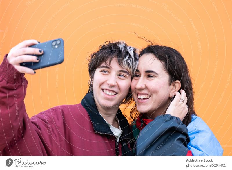 Young lesbian couple taking selfie on smartphone memory lgbt love relationship positive young homosexual mobile phone girlfriend photography moment soulmate