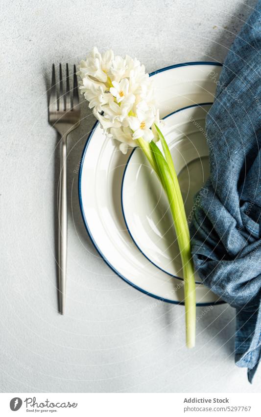 Spring table setting with hyacinth cutlery dinner dinnerware festive concrete flora floral flower Easter food fork beauty holiday ceramic rustic leaves fresh
