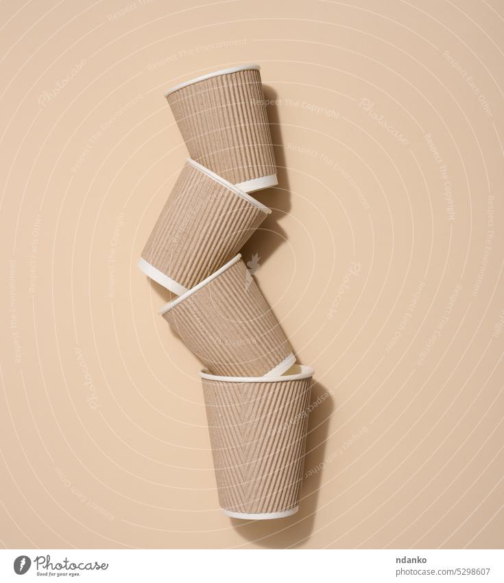 Brown disposable cups for coffee and tea on a beige background, top view paper picnic plastic-free recycling ecology environment flat garbage landfill nobody