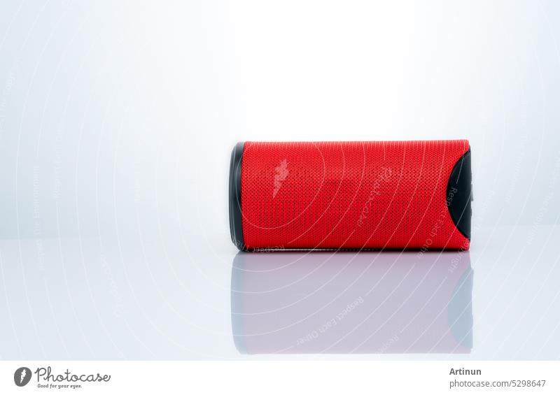 Wireless portable speaker isolated on white background. Red Digital portable speakers. Small sound music box speaker. Modern design mini portable Wireless loudspeaker. Digital wireless technology.