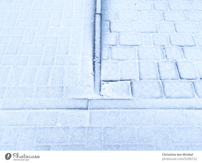 A fine layer of snow covers the paving stones snowy Paving stone Background picture Snow Pattern texture Structures and shapes Winter Smoothness White