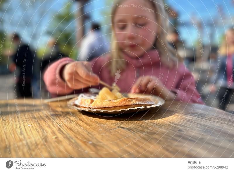 Child eats a waffle with stewed apple and powdered sugar Girl Eating Waffle Delicious Food Dessert cute Nutrition Candy Hand To enjoy Baked goods Cake Dough