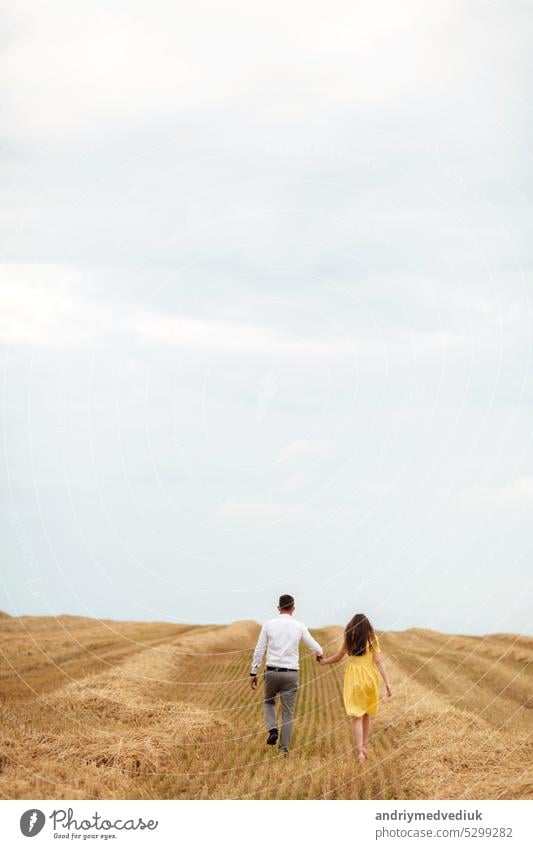 Happy young couple on straw, romantic people concept, beautiful landscape, summer season. love portrait field woman countryside dress haystack rural meadow