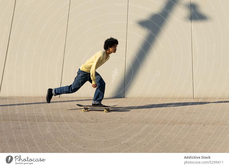 Energetic man skateboarding on street skater wall activity energy extreme urban male young stunt sport dynamic active perform skill motion hobby practice leap