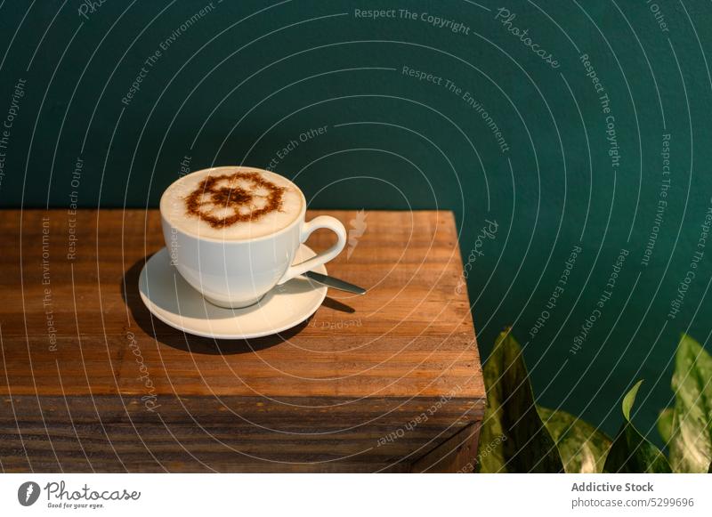 Cup of cappuccino on wooden cupboard cocoa coffee foam beverage hot drink aroma aromatic caffeine delicious tasty vietnamese morning energy ceramic mug powder