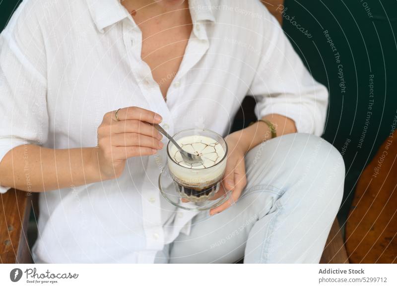 Woman with cup of coffee and spoon in cafe woman drink rest beverage pensive thoughtful relax break female vietnam young enjoy wooden fresh concentrate aromatic