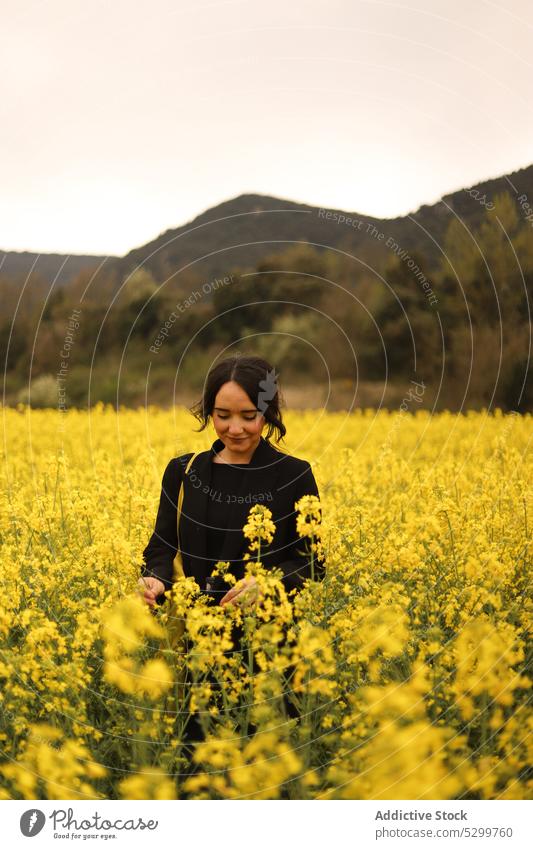 Content woman in blooming field flower countryside meadow calm nature hill environment female peaceful blossom flora tranquil young serene harmony rural