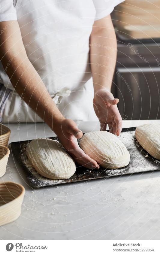 Crop baker preparing sourdough bread in kitchen person cook flour prepare proofing basket table ingredient pastry arrange craft bakery apron food culinary
