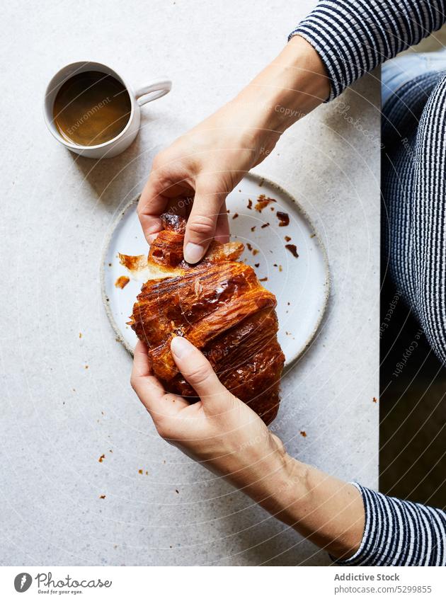 Faceless person eating delicious croissant breakfast baked coffee food homemade table morning yummy pastry dessert plate tasty cup fresh meal drink sweet