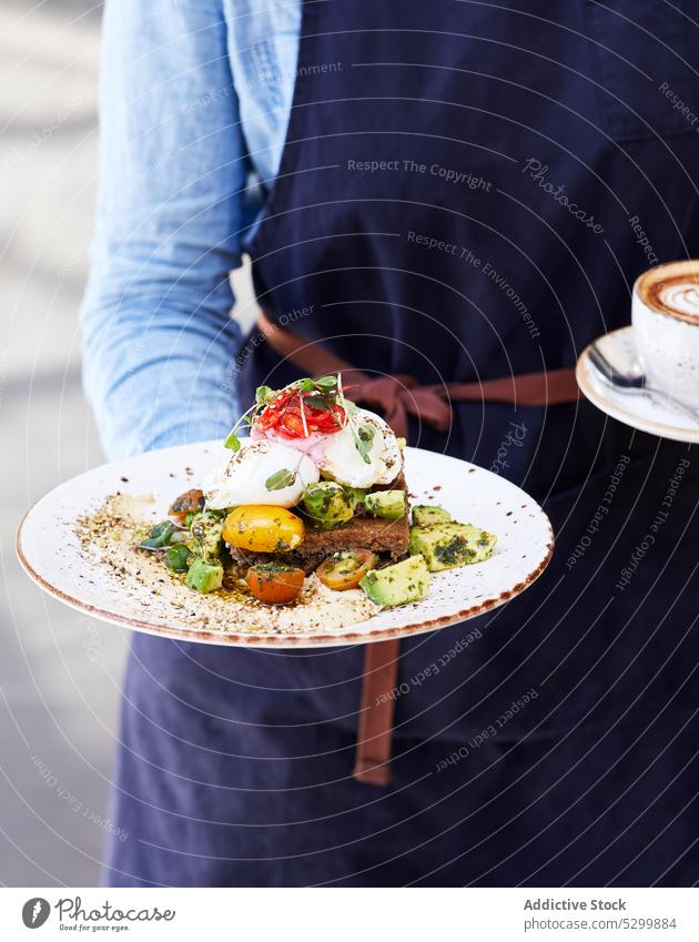 Person with delicious Poached Egg and Avocado Toast with vegetables person toast bread poach egg avocado red pepper cherry tomato tasty sandwich greenery fresh