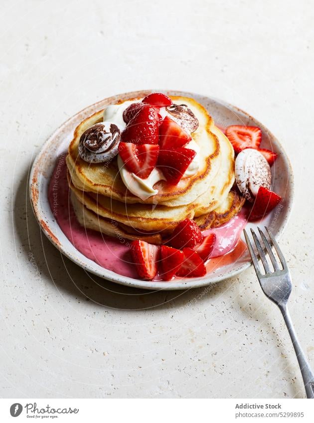 Delicious pancakes with strawberries and cream strawberry yogurt dessert sweet delicious food breakfast yummy plate fork appetizing tasty fresh serve portion