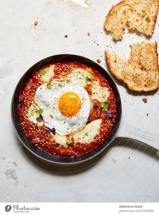 Delicious breakfast with fried egg and tomatoes shakshuka pan bread cheese food delicious appetizing table cuisine tasty fresh yummy kitchen meal culinary