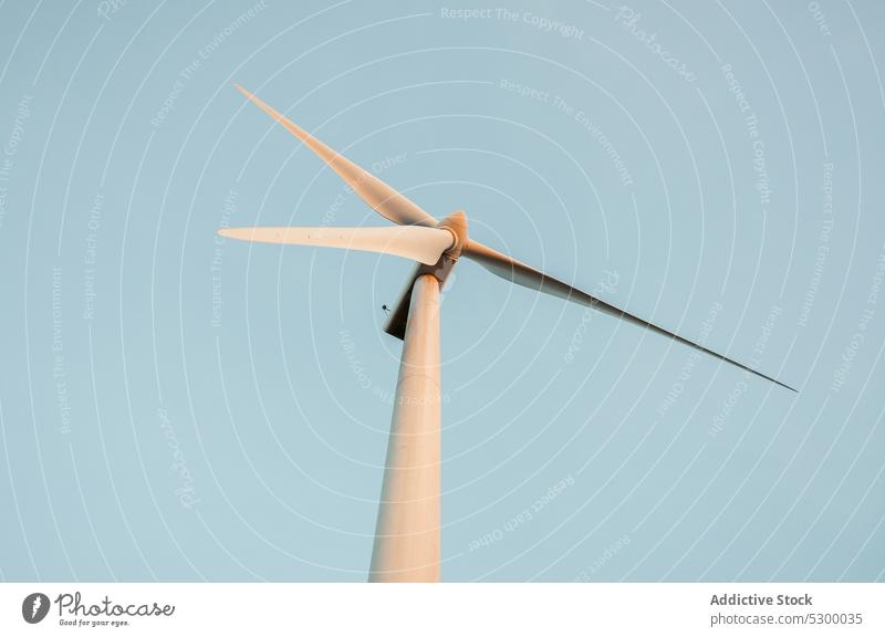 Windmill against cloudless blue sky windmill nature construction exterior power structure environment building industry reusable reclaimable spain daytime