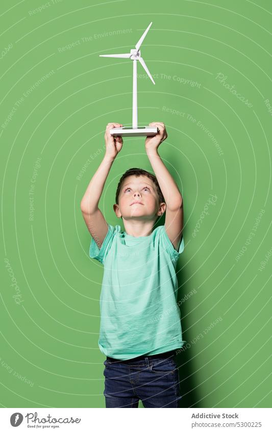 Smiling kid with windmill mockup overhead boy child happy power energy eolic generator preteen focus casual cheerful smile joy childhood positive excited