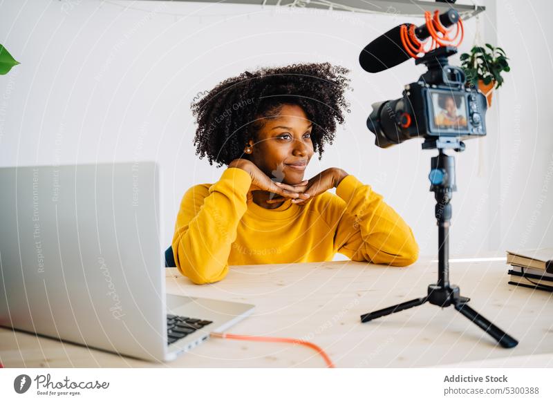 Focused African American woman recording podcast blogger camera laptop studio professional using work shoot microphone photo camera vlog concentrate influencer