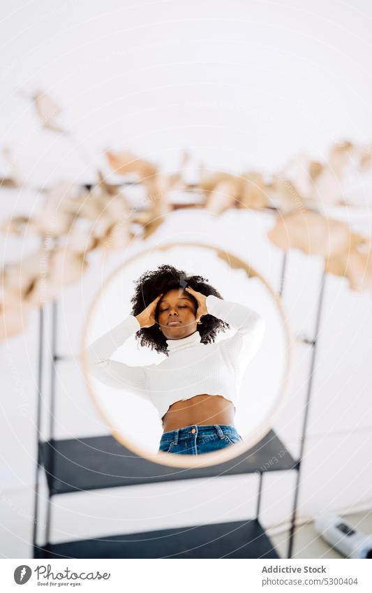 Calm black woman reflecting in mirror reflection eyes closed relax dreamy appearance calm casual personality curly hair young female afro peaceful tranquil