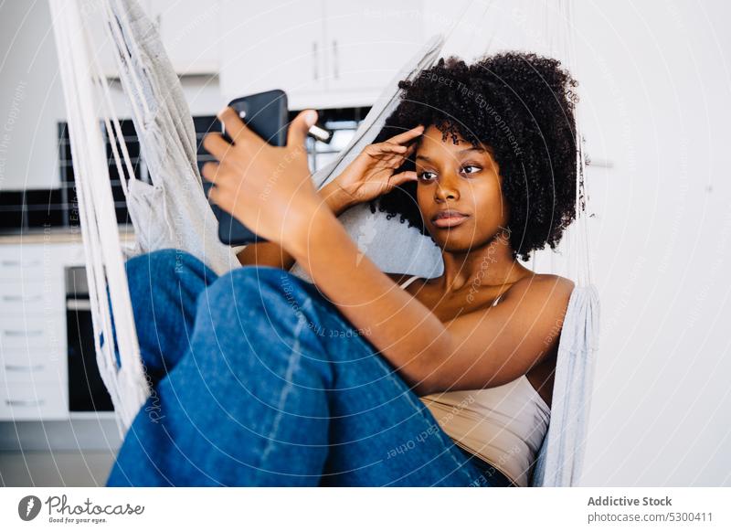 Black woman taking selfie on hammock smartphone using african american black young female happy positive casual rest curly hair mobile self portrait cellphone