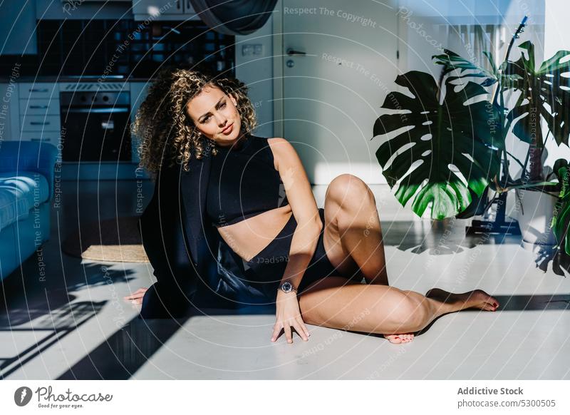 Sensual woman in underwear on floor sensual gorgeous confident style fashion appearance model feminine curly hair female young plant relax allure rest jacket