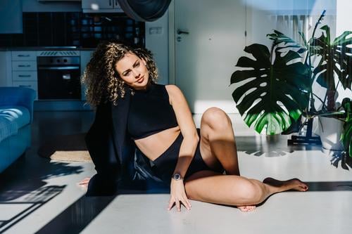 Sensual woman in underwear on floor sensual gorgeous confident style fashion appearance model feminine curly hair female young plant relax allure rest jacket