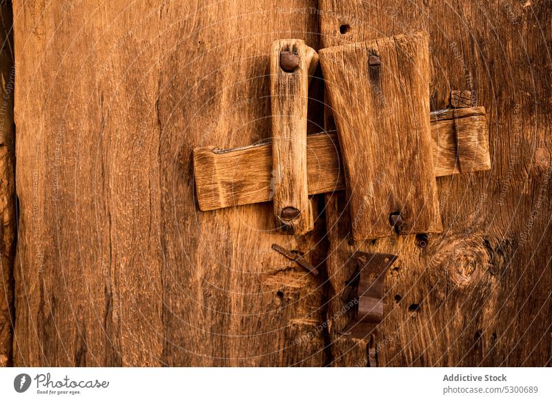 Medieval lock on wooden door ancient historic shabby mechanism old aged close sahara mauritania africa architecture construction weathered detail block culture